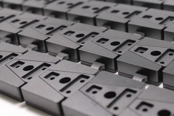 Low volume manufacturing production line with workers assembling parts and quality inspection processes